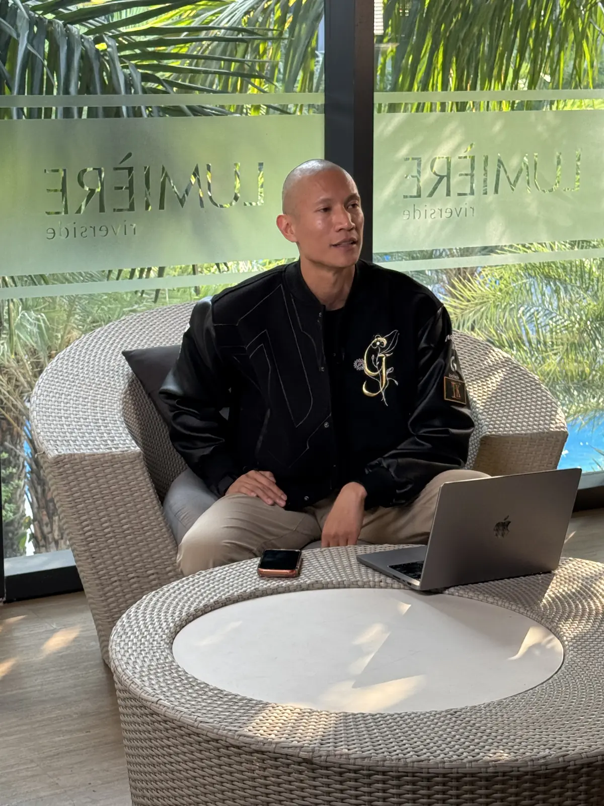 TK Nguyen sitting at a laptop at Lumiere in Nha Trang during the Day 11 session of the Infinite Leverage Blueprint