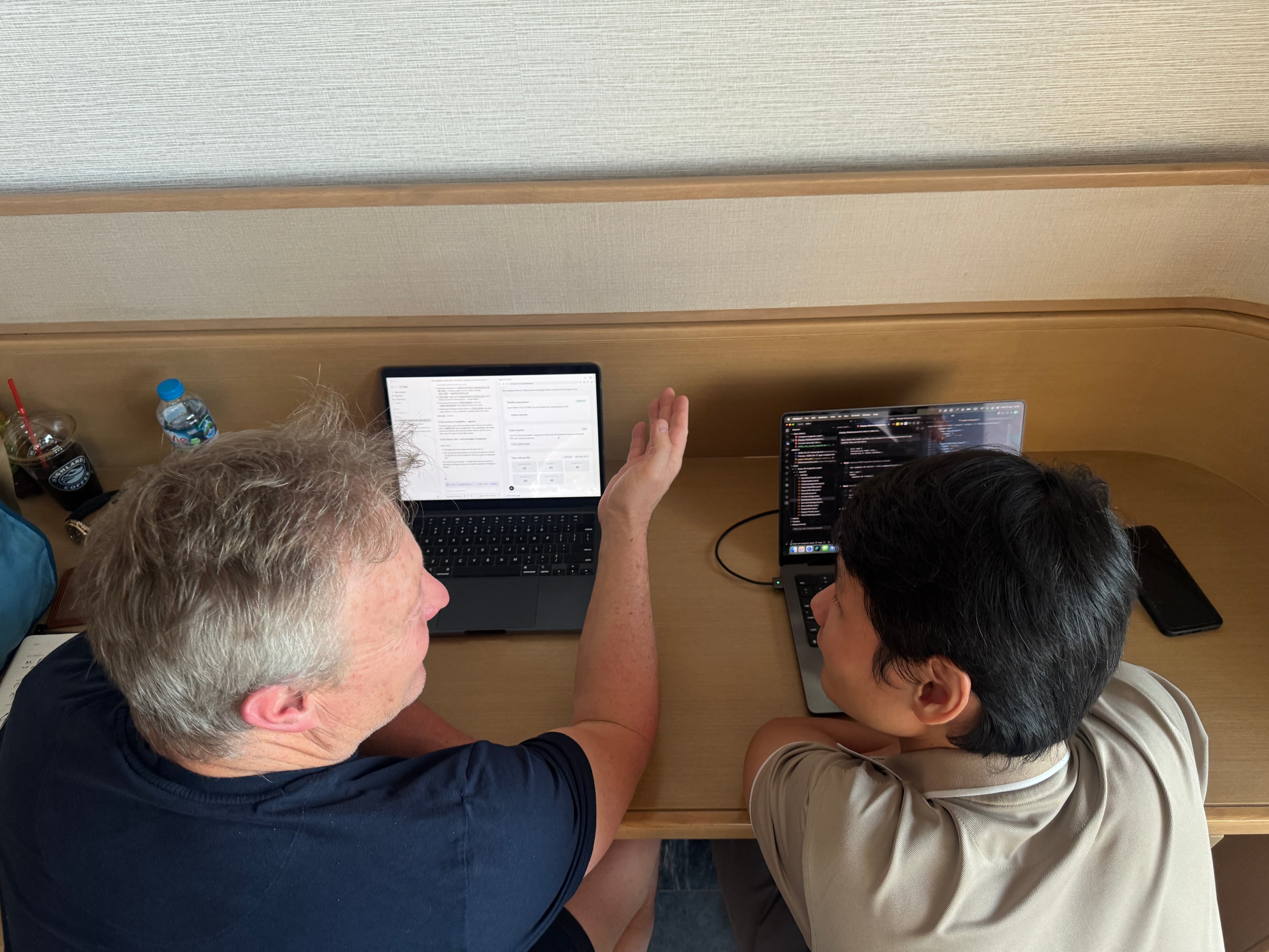 Overhead view of James and Trac working together on laptops during the sprint